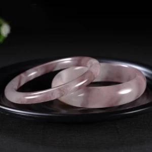 Two stacked light purple jade bangles showing marbled natural veining from top view