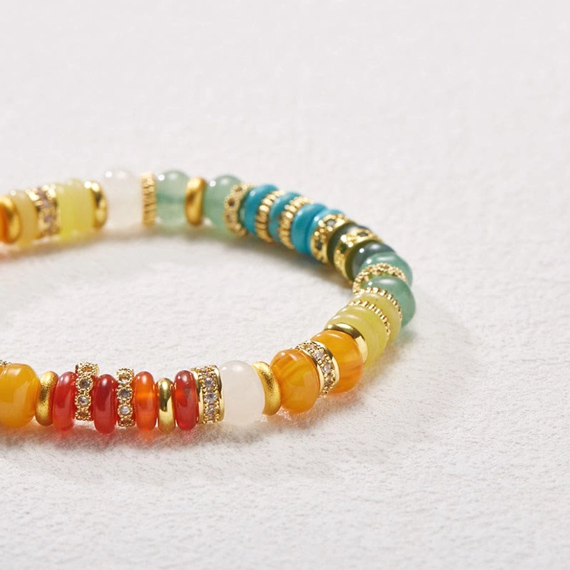 Rainbow gemstone jade bracelet close-up side view showing red agate turquoise and yellow agate beads with copper accents
