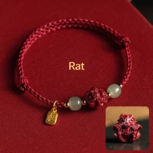 Rat zodiac Hetian jade cinnabar lucky bracelet with red cord and fu character pendant on burgundy velvet background