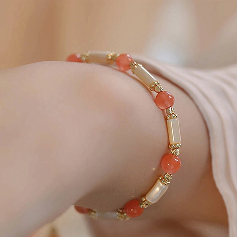 Double-layer red agate and shell bead blessing bracelet worn on wrist overhead view, daily wear styling