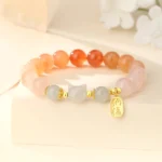Red agate Hetian jade cat Fu character sterling silver bracelet flat lay with floral decoration