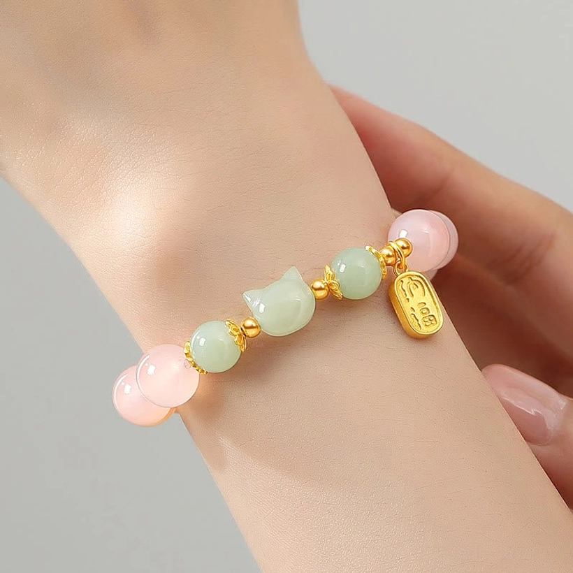 Hetian jade cat Fu character bracelet worn on wrist close-up with hand detail