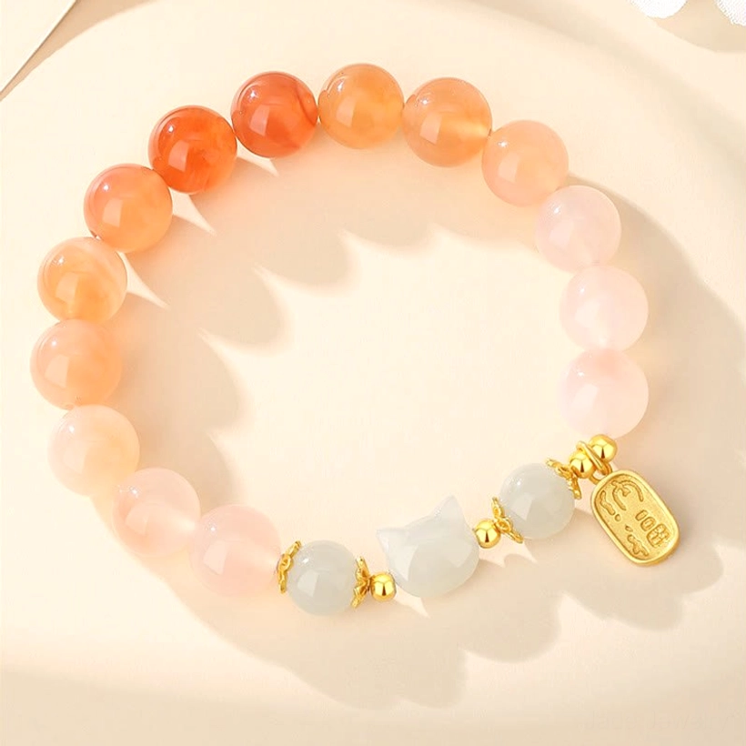 Full strand red agate gradient jade cat bead bracelet with Fu pendant and gold hardware overhead view