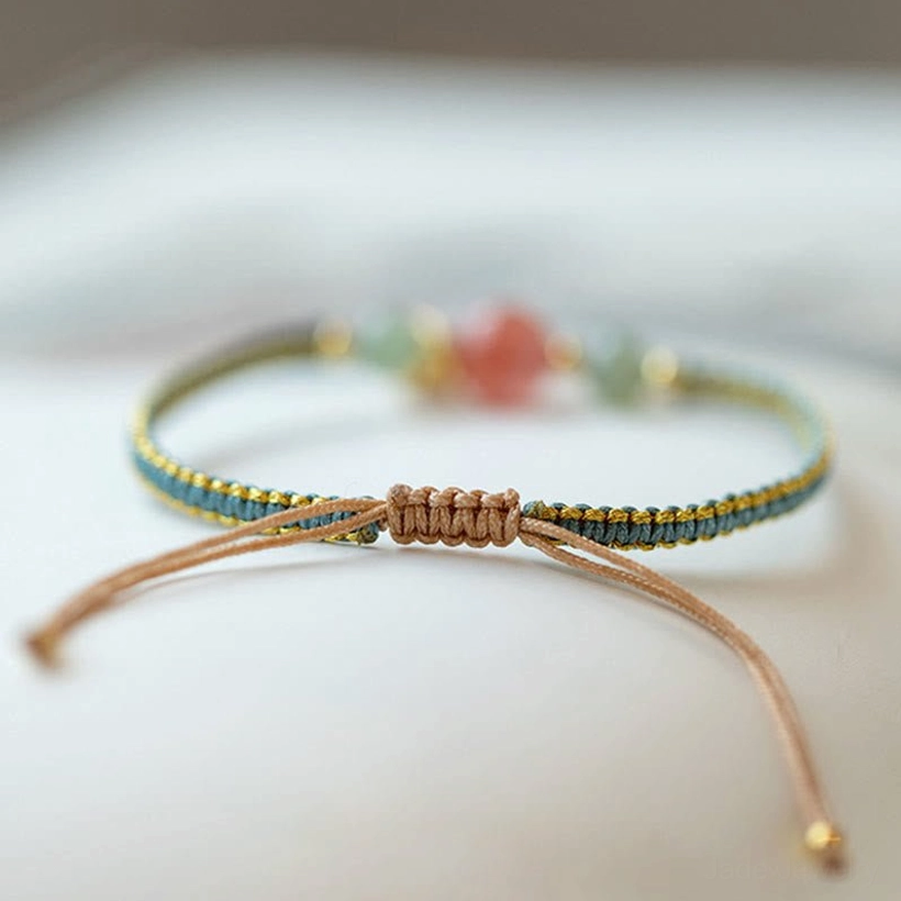 Red agate lotus bracelet with adjustable knot closure and braided string design