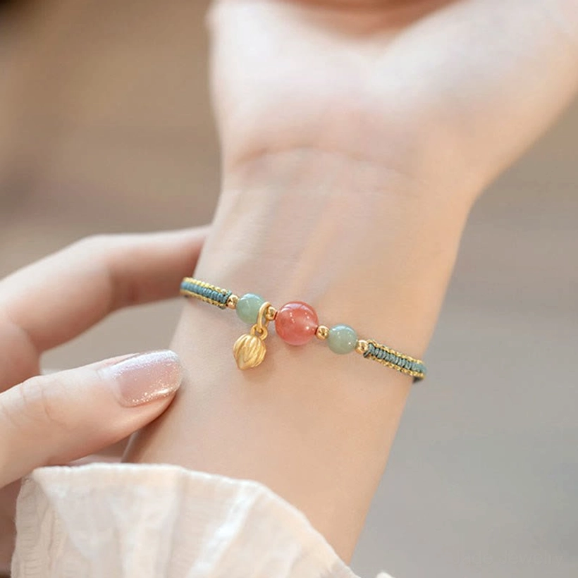 Front view of red agate lotus stone bracelet displaying all beads on wrist with neat braided design