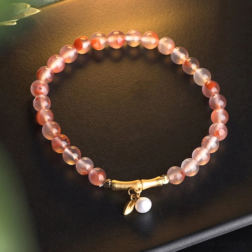 South Red Agate Pearl bracelet with gold bamboo clasp and white pearl pendant on dark matte background