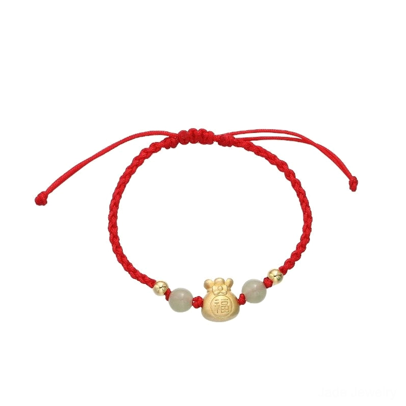 Single red rope jade prosperity braided bracelet flat lay on white background highlighting woven rope texture, gold Fu money bag charm, and spacer beads
