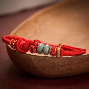 Chinese knot jade bracelet detail shot showing woven knots and jade beads