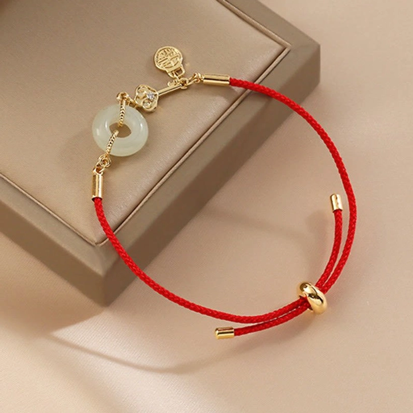 Jade peace bracelet with heart charm and fortune tag showing multiple symbolic elements together