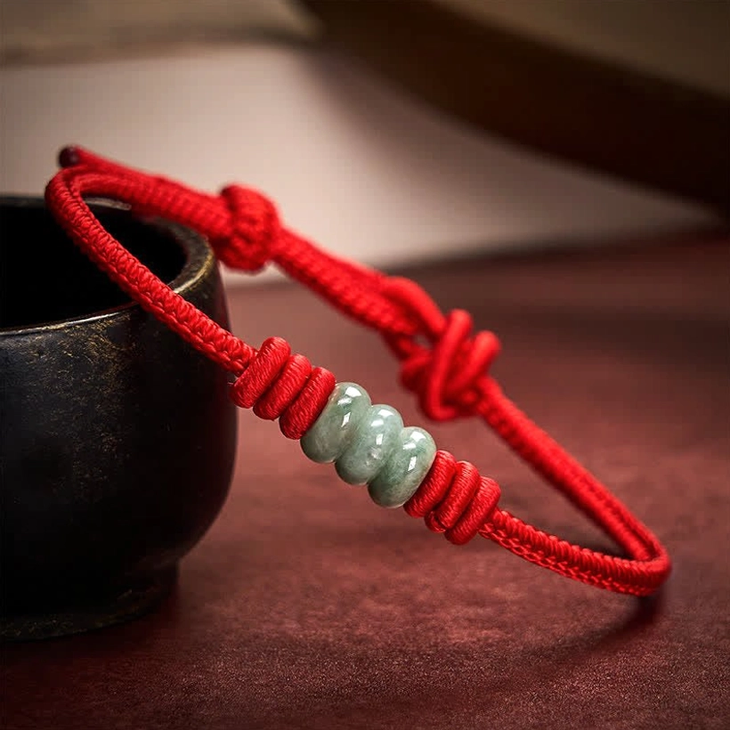 Red jade protection bracelet with braided red cord and polished green jade beads, versatile style for everyday wear