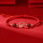 925 sterling silver snake koi jade cinnabar bracelet with red braided string on red satin background