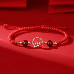 925 sterling silver snake koi jade cinnabar bracelet with red braided string on red satin background