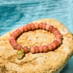 Strawberry Quartz Cyan Jade Lucky Cat Beads Healing Bracelet - Pink Stone Flat Lay with Water Backdrop
