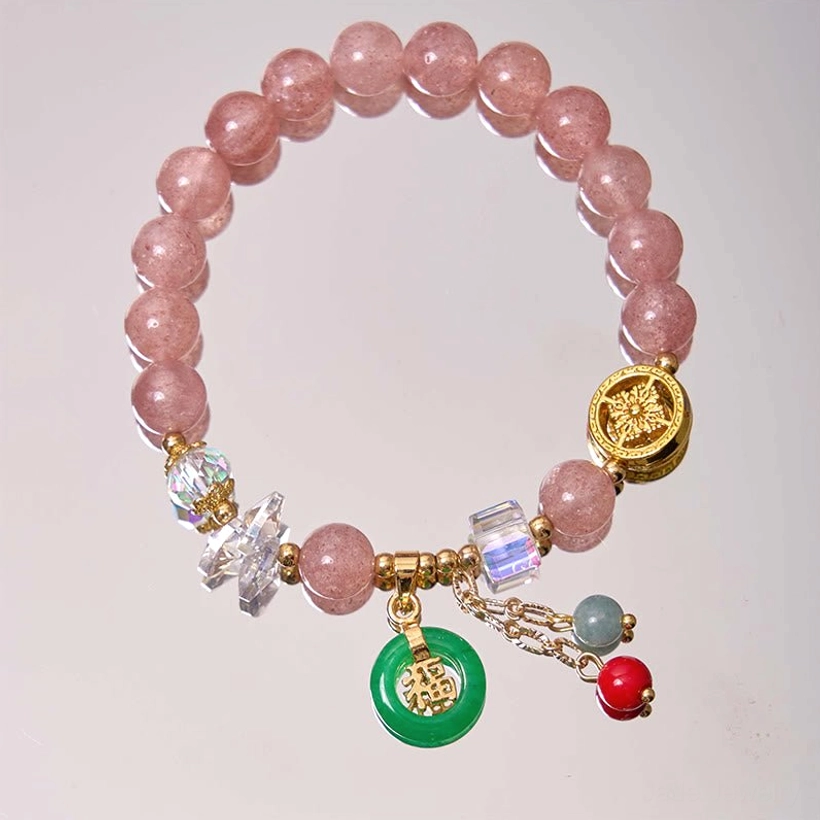 Strawberry quartz beaded bracelet overhead on neutral background showing round pink stones and gold Fu character bead