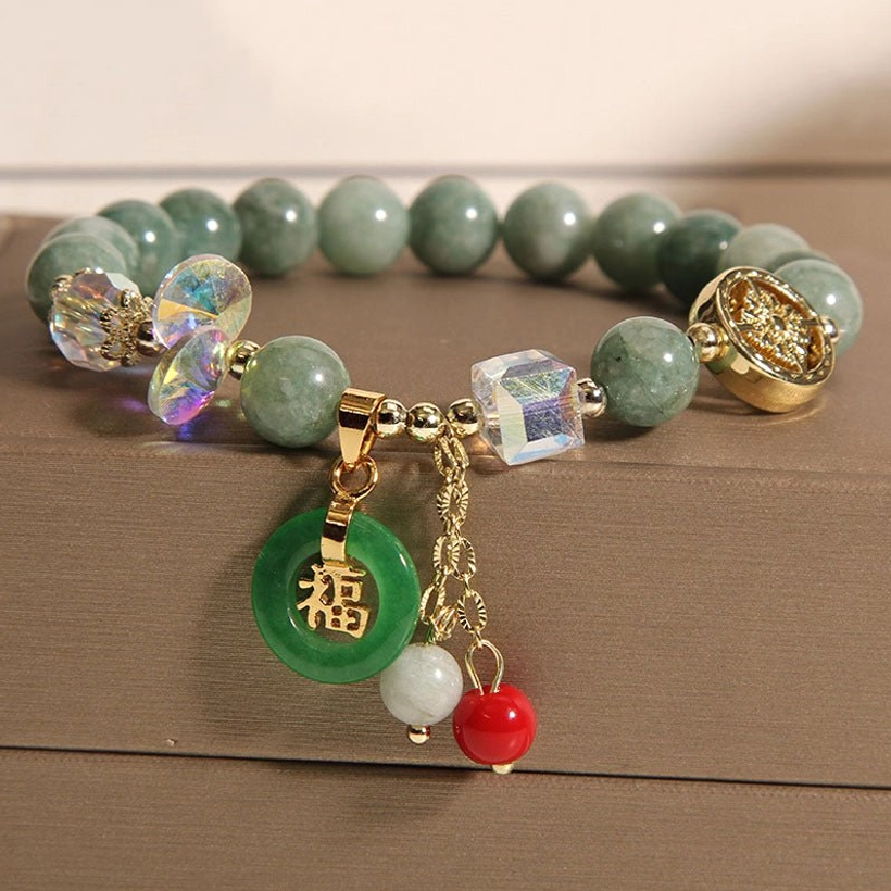 Strawberry quartz Fu charm bracelet wrist overhead angle showing pink quartz beads and gold accents