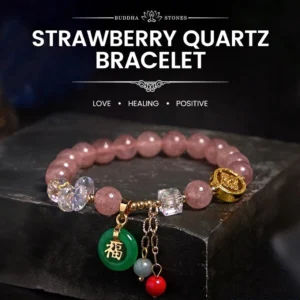 Strawberry quartz Fu character bracelet with pink beads and green jade charm on dark stone display