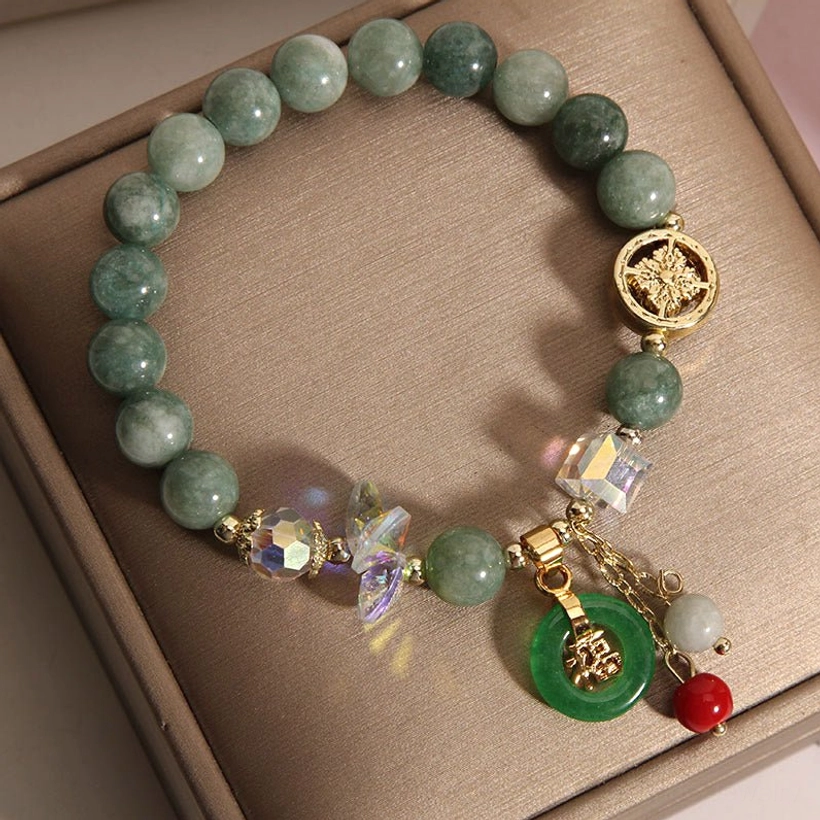 Pink strawberry quartz and jade Fu character bracelet flat lay showing complete design and materials