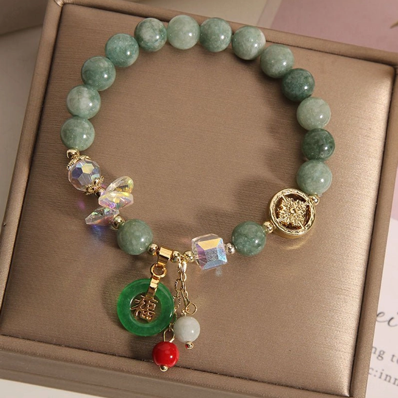 Strawberry quartz jade Fu bracelet close-up showing pink quartz stone texture and green jade accents