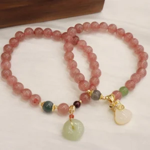 Two strawberry quartz peace buckle bracelets with jade pendants displayed side by side, showing both coin purse and round buckle designs