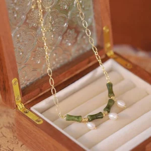 Tianshan jade bamboo pearl necklace displayed in luxury wooden jewelry box with gold chain