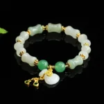 Tianshan jade Fu character prosperity bracelet with white jade beads, green aventurine accents, and gold copper spacers - angled display
