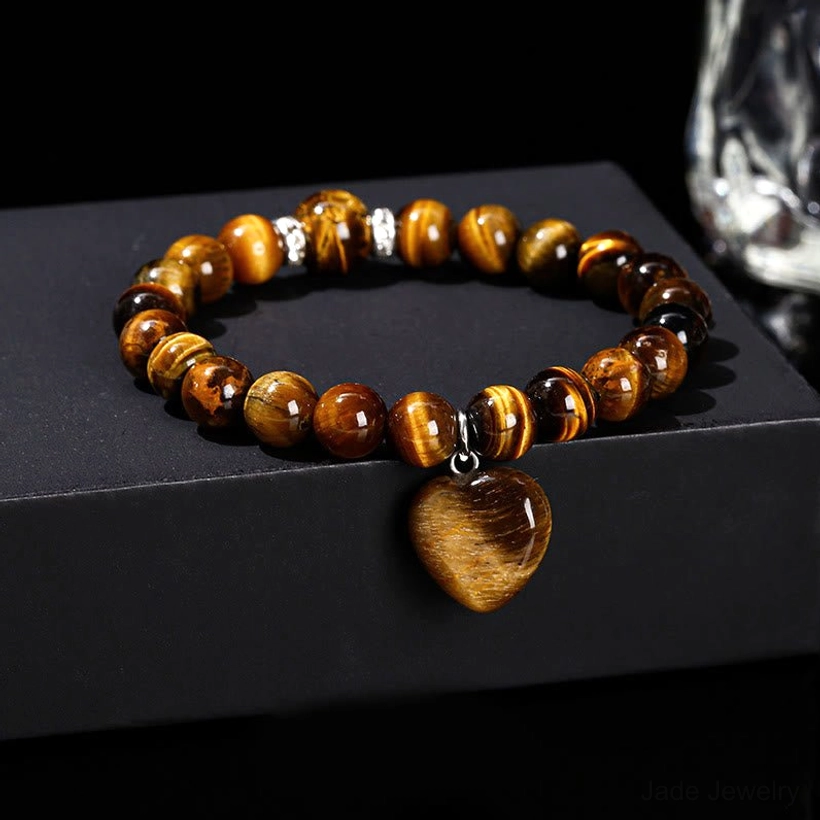 Tiger Eye beaded heart charm bracelet on black reflective background
