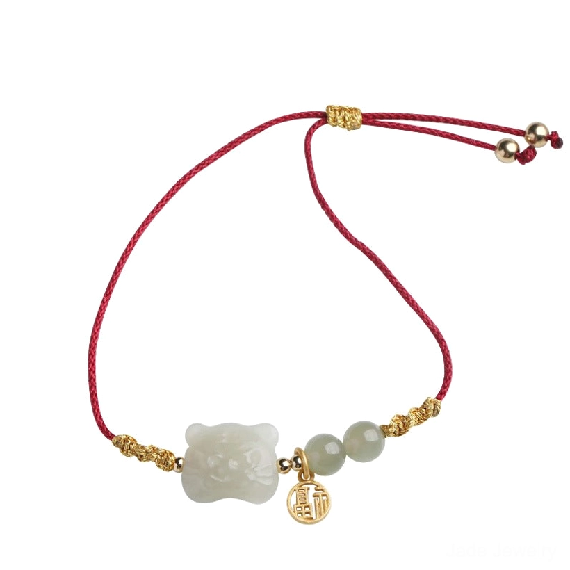 Tiger zodiac jade bracelet flat lay isolated product view showing full adjustable red string design with sliding knot closure and jade elements