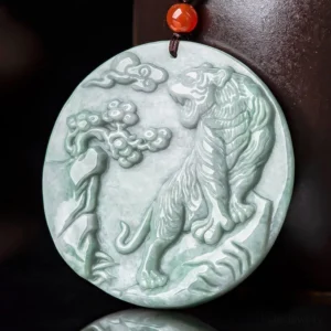 Tiger zodiac jade necklace side view showing black cord with red agate bead accent, carved tiger and pine pattern detail