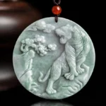 Hand-carved tiger jade protection necklace pendant, 52mm round light green jade with intricate carving details, displayed on dark background
