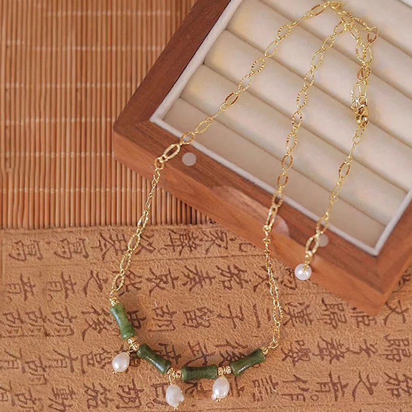 Tianshan jade bamboo pearl necklace flat lay on bamboo mat with authentic cultural background