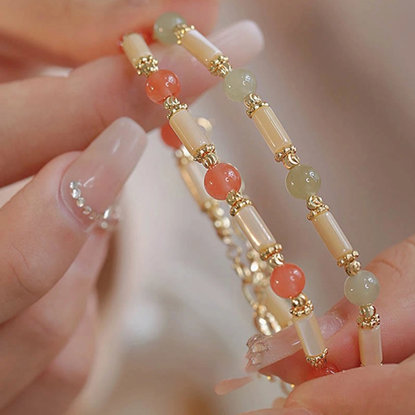 Tridacna stone shell and jade beads with gold metal accents protective blessing bracelet detailed view