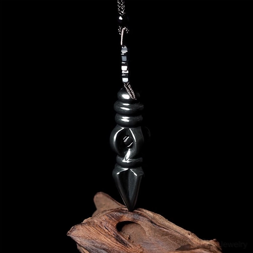 Vajra Dorje pendant overhead view showcasing compact Buddhist symbol carved design with matching black necklace cord on driftwood