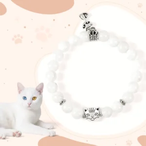 White chalcedony cat beaded bracelet with silver cat charm on pink paw print background
