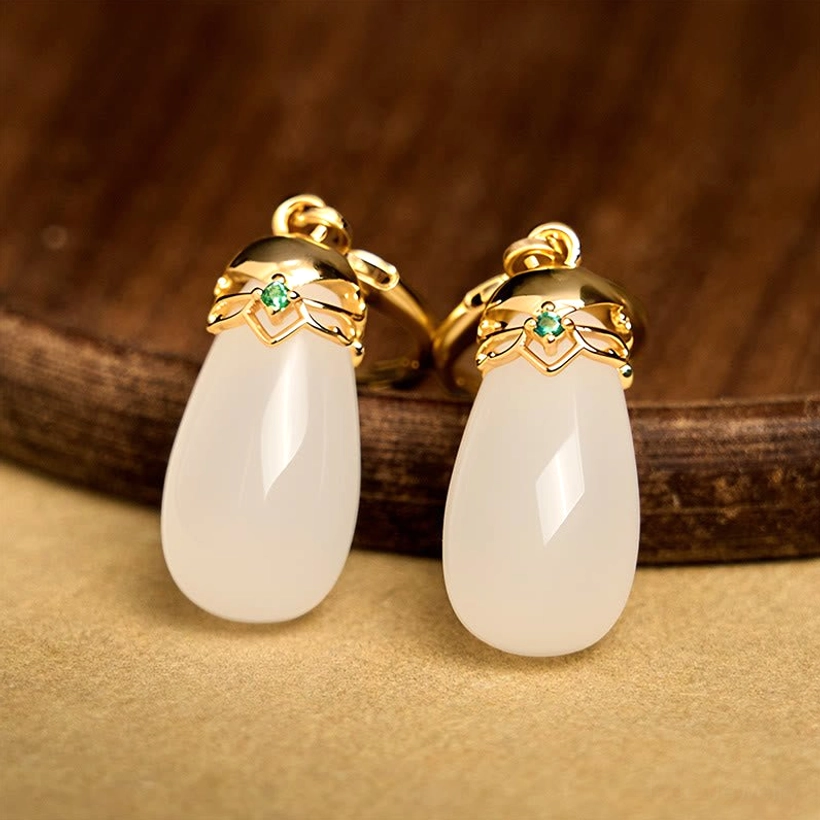 White chalcedony water drop earrings detail shot polished gemstone finish pale stone beauty light reflection
