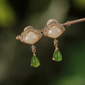 White and cyan jade fan drop earrings with gold plating on natural wooden branch