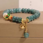 White jade and white agate butterfly abacus bracelet with enamel butterfly charm displayed in luxury brown jewelry box, close-up overhead view