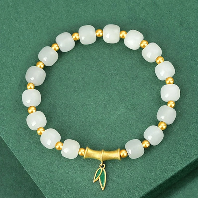 Full strand Hetian white jade bamboo bracelet laid flat showing all beads and gold-tone spacers