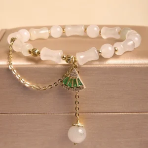 Tianshan white jade bamboo bracelet with green fan charm and pearl drop pendant, displayed in luxury gold jewelry gift box