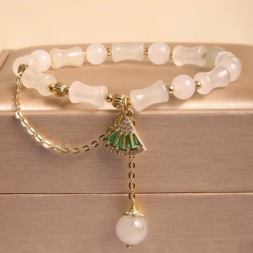 Tianshan white jade bamboo bracelet with green fan charm and pearl drop pendant, displayed in luxury gold jewelry gift box