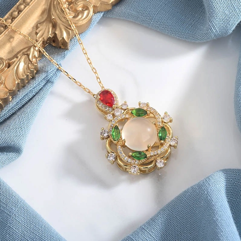 White jade and red crystal dual gemstone necklace, side view on fabric backdrop