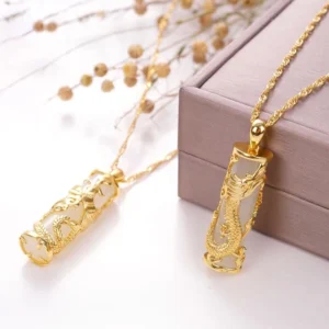 White jade dragon pendant necklace with gold electroplated copper setting, displayed on luxury gift box with dried flowers and natural styling