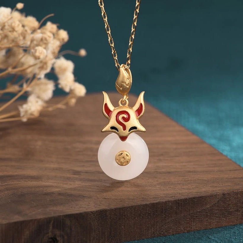 White jade fox protection necklace pendant with antique copper fox charm and cable chain on wooden board with dried flowers