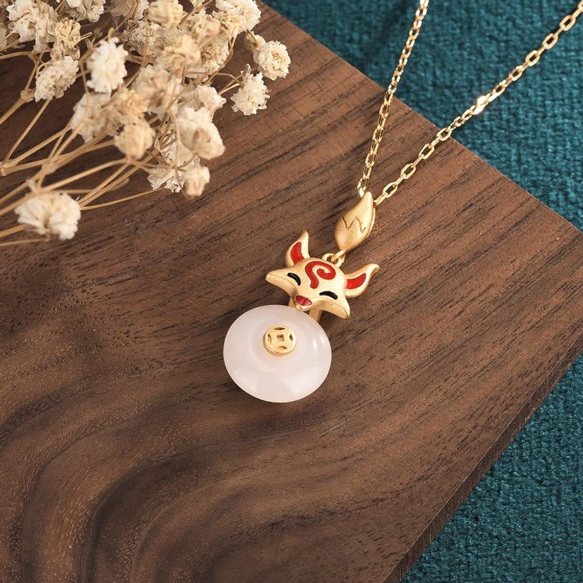 Right side view of white jade fox lucky necklace with full front pendant display on green fabric background