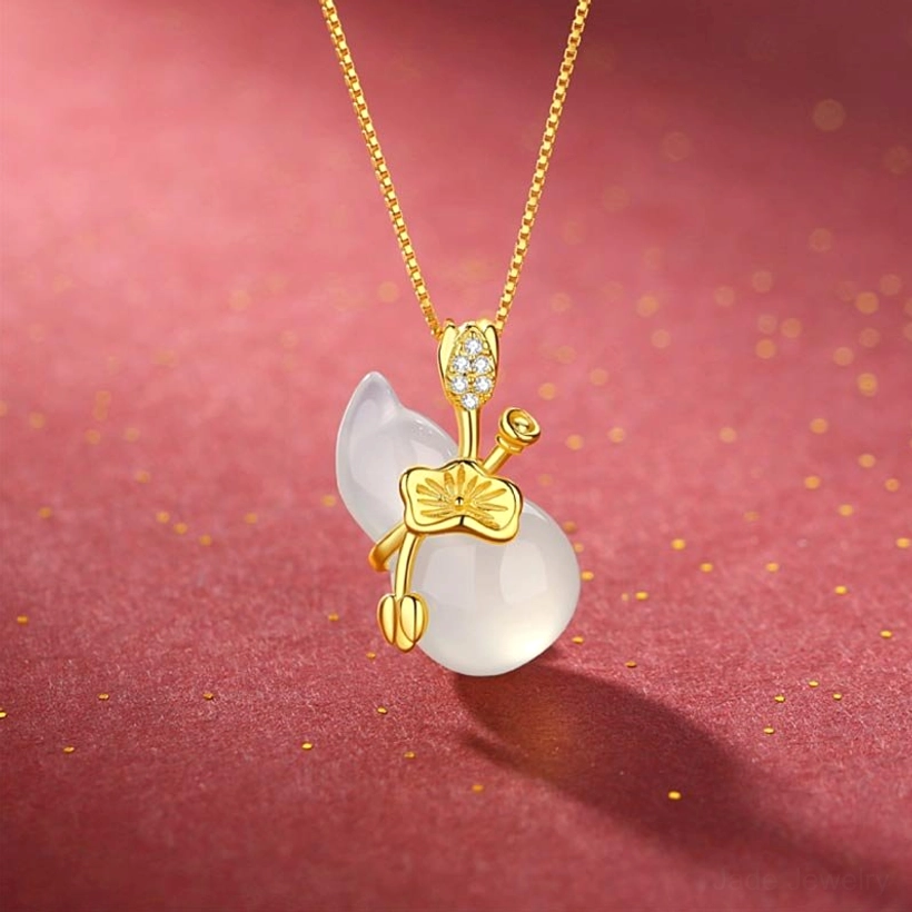 White jade gourd pendant necklace with gold lotus ornament and crystal accents, three-quarter front view