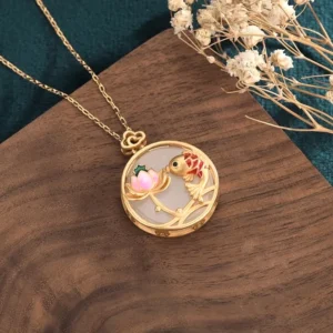 Handcrafted white jade koi lotus pendant oblique angle showcasing heart-shaped hanging clasp, hollow metal frame, and intricate carving details with enamel color accents