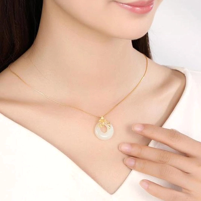 White jade lotus necklace worn at collarbone position, showing real-life daily styling with thin elegant gold chain and natural skin tone, authentic wearability demonstration
