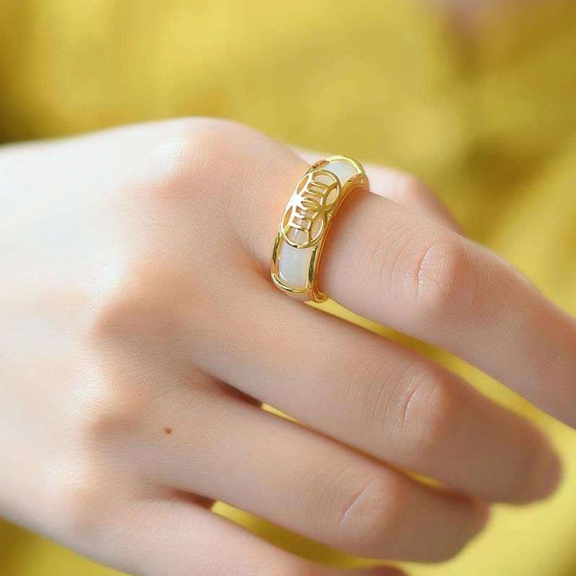 White jade protection ring worn on index finger, showcasing minimalist gold-plated dual-tone design and natural jade luster