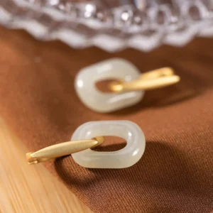 pale white oval jade hoop earrings brushed silver fasteners top view