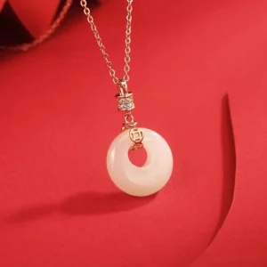 Creamy white jade peace buckle pendant with cubic zirconia sterling silver bail and rose gold chain detail close-up