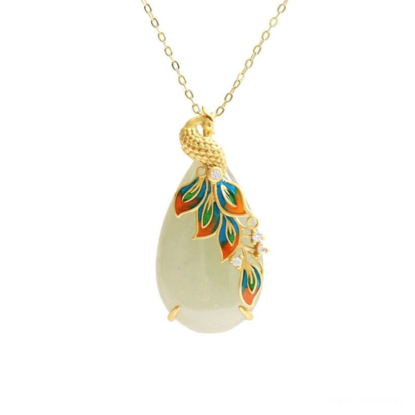 Full front flat lay of white jade peacock necklace, thin gold chain with light-toned jade pendant, intricate peacock enamel design